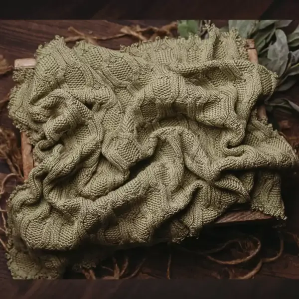 Green fringed newborn photography blanket with sweater-knit texture