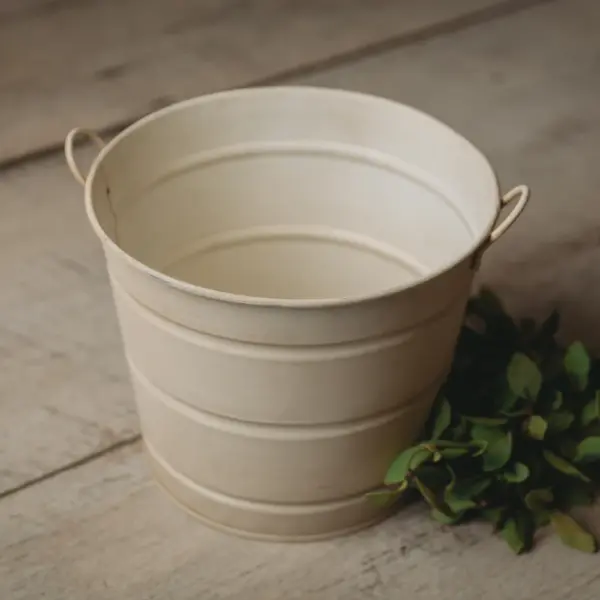 White newborn photography posing pail bucket