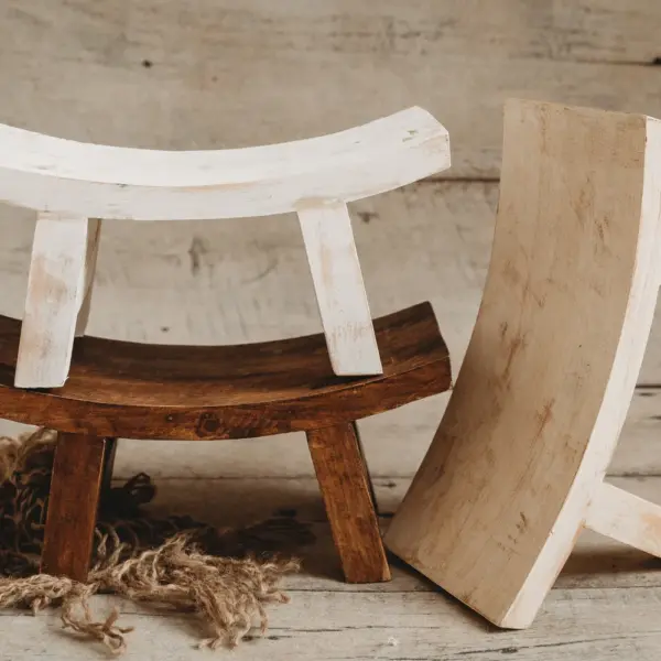 Round newborn sitter stool used for posed newborn photography in natural wood