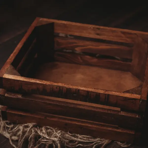 Wooden newborn photography crate used as a posing and styling prop in natural