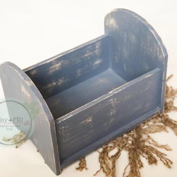 Wooden newborn photography bed used for posed newborn photography in gray